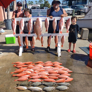 Family stands on the Panama City Beach dock after a successful Saltshaker Charters fishing trip in Florida