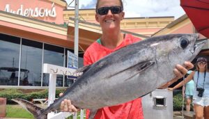 Lady with her catch on the Panama City Beach dock after a successful Saltshaker Charters fishing trip in Florida